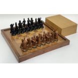 A complete chess set comprising wooden board with acrylic surface (w- 39.5cm) and boxed set of resin