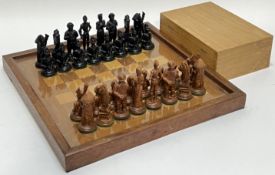 A complete chess set comprising wooden board with acrylic surface (w- 39.5cm) and boxed set of resin