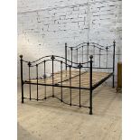 A Victorian style metal 5' king size bed, the frame with brass ball finials. H130cm, L218cm, W155cm