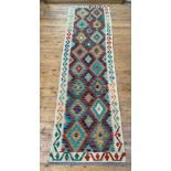 A Chobi kilim runner rug of typical design, 290cm x 81cm