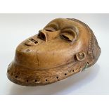 A southern African carved wooden wall mask, possibly Chokwe, Angola, with almond eyes, parted