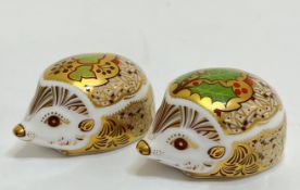 Two Royal Crown Derby paperweights modelled as hedgehogs, one with 'Holly' decoration (marked