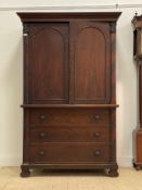 A 19th century continental mahogany linen press, the projecting cornice over two arch panelled doors