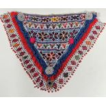 A South American beadwork V shaped chest panel with stylized flower heads, v and inverted v panels