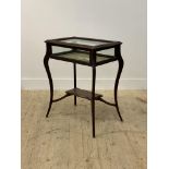 A late 19th / early 20th century mahogany table vitrine, the top of serpentine outline, raised on