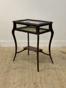 A late 19th / early 20th century mahogany table vitrine, the top of serpentine outline, raised on