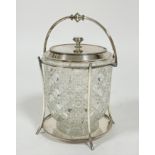 An Edwardian Epns mounted cut crystal biscuit barrel with swing handle to top and splay column