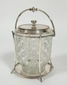 An Edwardian Epns mounted cut crystal biscuit barrel with swing handle to top and splay column