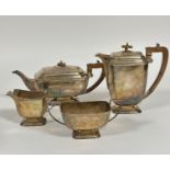 An Edinburgh 1930's silver four piece tea and coffee set of rectangular panelled form, with square