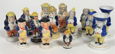 A collection of fourteen 19thc Staffordshire novelty figure pepperettes and salt sellers, some in