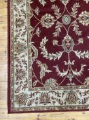 A Persian style rug, the red ground with herati motif and bordered 160cm x 233cm
