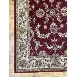 A Persian style rug, the red ground with herati motif and bordered 160cm x 233cm