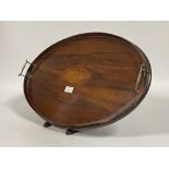 An Edwardian mahogany twin handled drinks tray, galleried sides enclosing boxwood conch inlay to