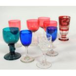 A collection of late 19th glass including three cranberry glasses on clear stems and another taller,