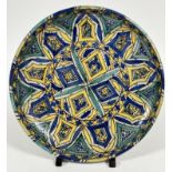A late 19thc early 20thc Iznik pottery dish, the central circular panel with four diamond panels