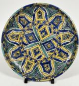 A late 19thc early 20thc Iznik pottery dish, the central circular panel with four diamond panels