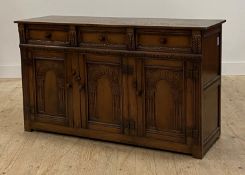 An oak dresser base of 18th century design, fitted with three drawers over three panelled