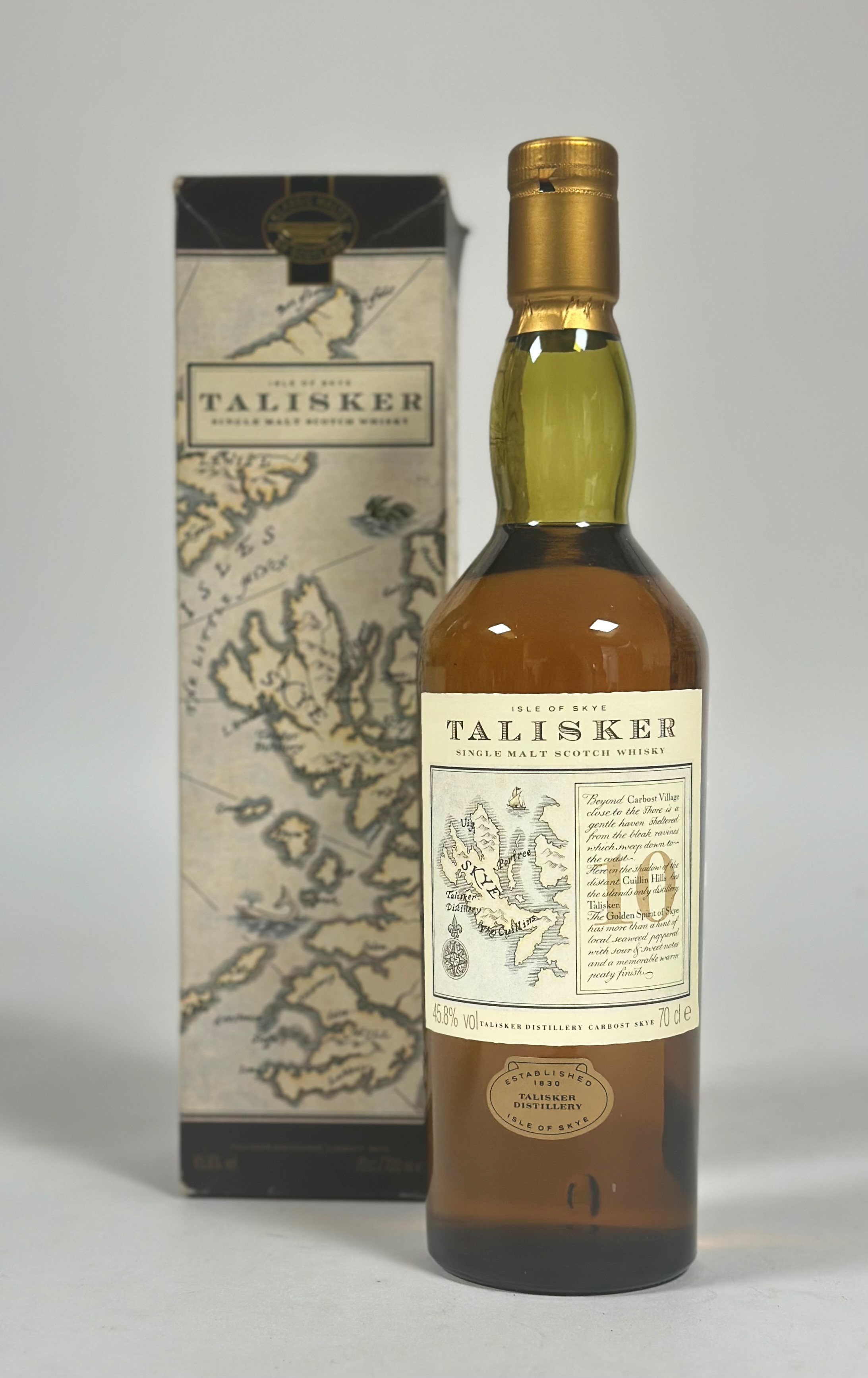 A bottle of Talisker 1990's 10 year old single malt whiskey, with a map label of the distillery in