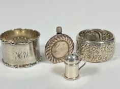 A Birmingham silver crenalated napkin ring, a Birmingham silver floral chased napkin ring, a