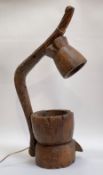 An unusual table lamp formed from and African carved wooden mortars. H75cm