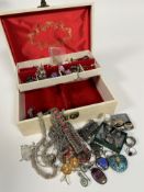 A white jewellery box containing a collection of costume jewellery including white metal chain