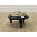 A Victorian ebonised circular footstool with upholstered seat D32cm