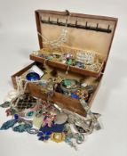 A brown jewellery box containing a large collection of costume jewellery including, two cultured