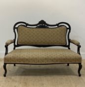 A late Victorian stained walnut drawing room settee, the scrolled and upholstered back, open arms