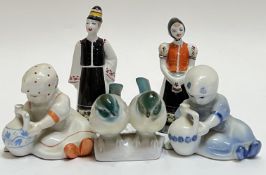 A group of Hungarian figures/models comprising a pair of Hollohaza porcelain figures in