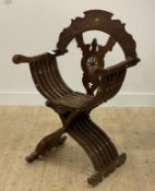 A Syrian teak Savonarola type folding chair, first half of the 20th century, profusely carved with