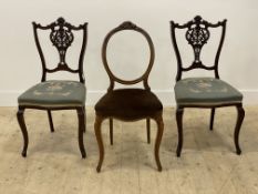 A pair of late Victorian / Edwardian side chairs, with floral carved crest rail and splat over