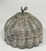 An Indian white metal circular fluted domed top casket with peacock knop to top and all over