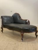 A Victorian walnut framed chaise longue of serpentine outline, upholstered in studded rexine, raised