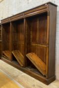 A stained hardwood three part bookcase, fitted with three frieze drawers over 15 adjustable shelves,