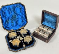 An Edwardian octagonal box containing a set of four Epns floral shaped fluted salts on pad feet,