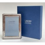 A boxed Carrs Silver hallmarked glazed photo frame with gadrooned edge and original velvet pouch (h-