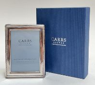 A boxed Carrs Silver hallmarked glazed photo frame with gadrooned edge and original velvet pouch (h-
