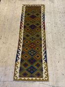 A Maimana kilim runner rug of typical geometric design with running dog border, 295cm x 89cm