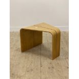 A contemporary bentwood birch ply end table H52cm, L62cm