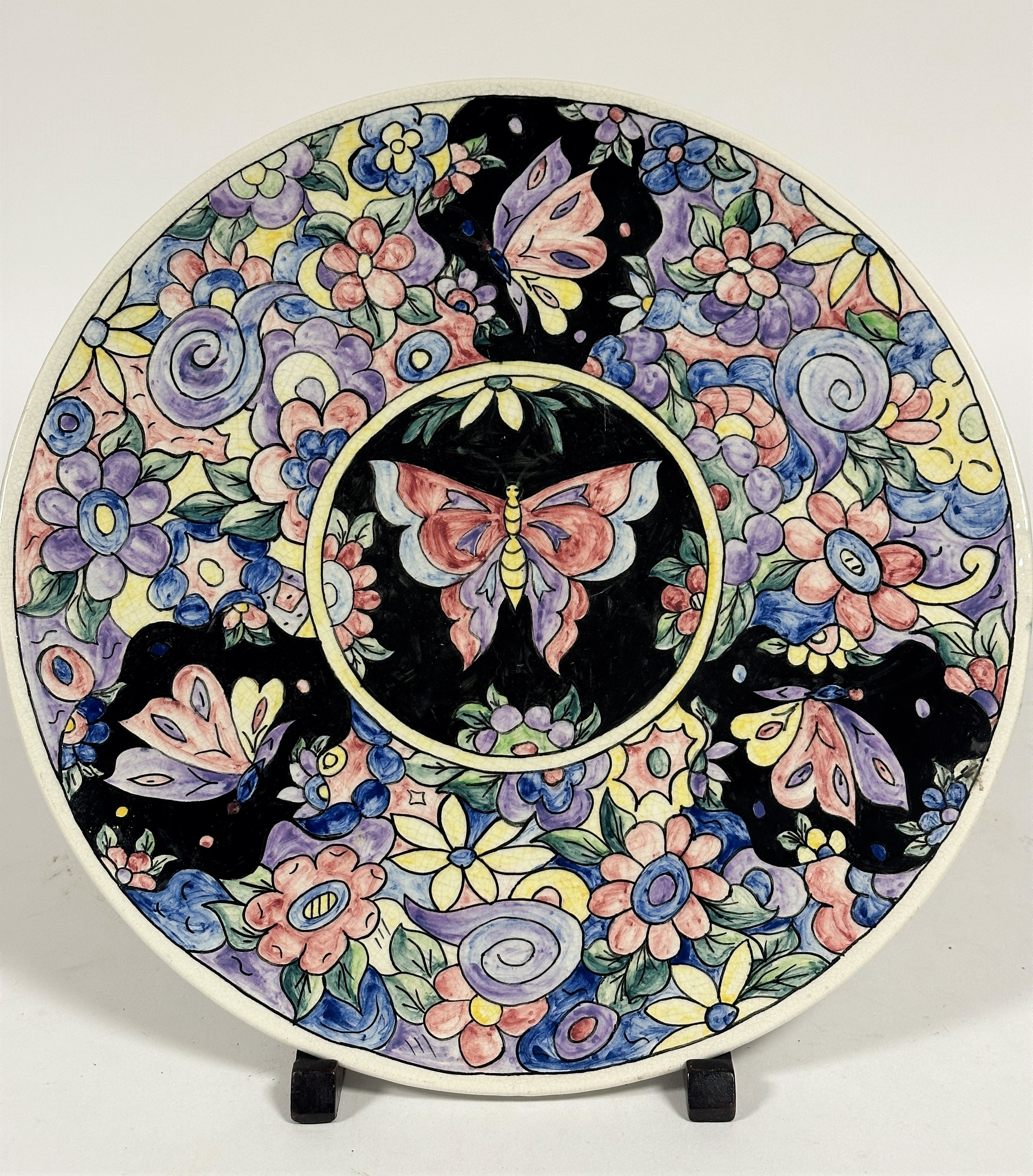 A 1937 pottery hand painted plaque by EB , the central circular panel with butterfly, enclosed