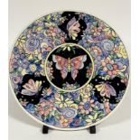 A 1937 pottery hand painted plaque by EB , the central circular panel with butterfly, enclosed