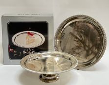 A boxed silver plated cake stand with engraved design and gadrooned edge (h- 10.5cm, w- 32cm),