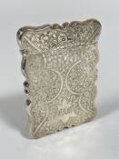 An Edwardian Sheffield silver Walker & Hall card case of rectangular scalloped form, with all over