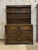 An oak dresser of 18th century design, the two height plate rack over two drawers and two