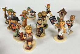 A collection of eleven Hummel figures including, The Professor, Extra, Extra, On Parade, Apple