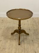 A gilt painted tripod table, the circular dished top over turned column and triple splay supports