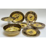 A Solian Ware part-service by Soho Pottery decorated in yellow/gilt with birds and sunset in the