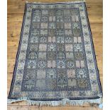 A Persian style silk and cotton garden rug, the ivory field with panels depicting various motifs,