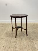 An Edwardian mahogany centre table, the circular top with chequered string inlay, raised on