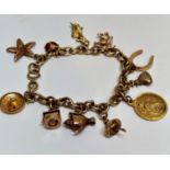 A 9ct gold circular link charm bracelet with circular clip fastening mounted with eleven charms